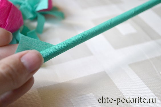 Обматываем палочку для суши зеленой гофрированной бумагой и закрепляем клеем
